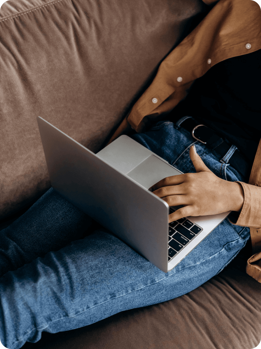 Person using laptop on couch